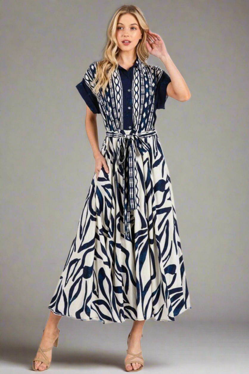 Woman wearing a blue and white patterned dress on a white background