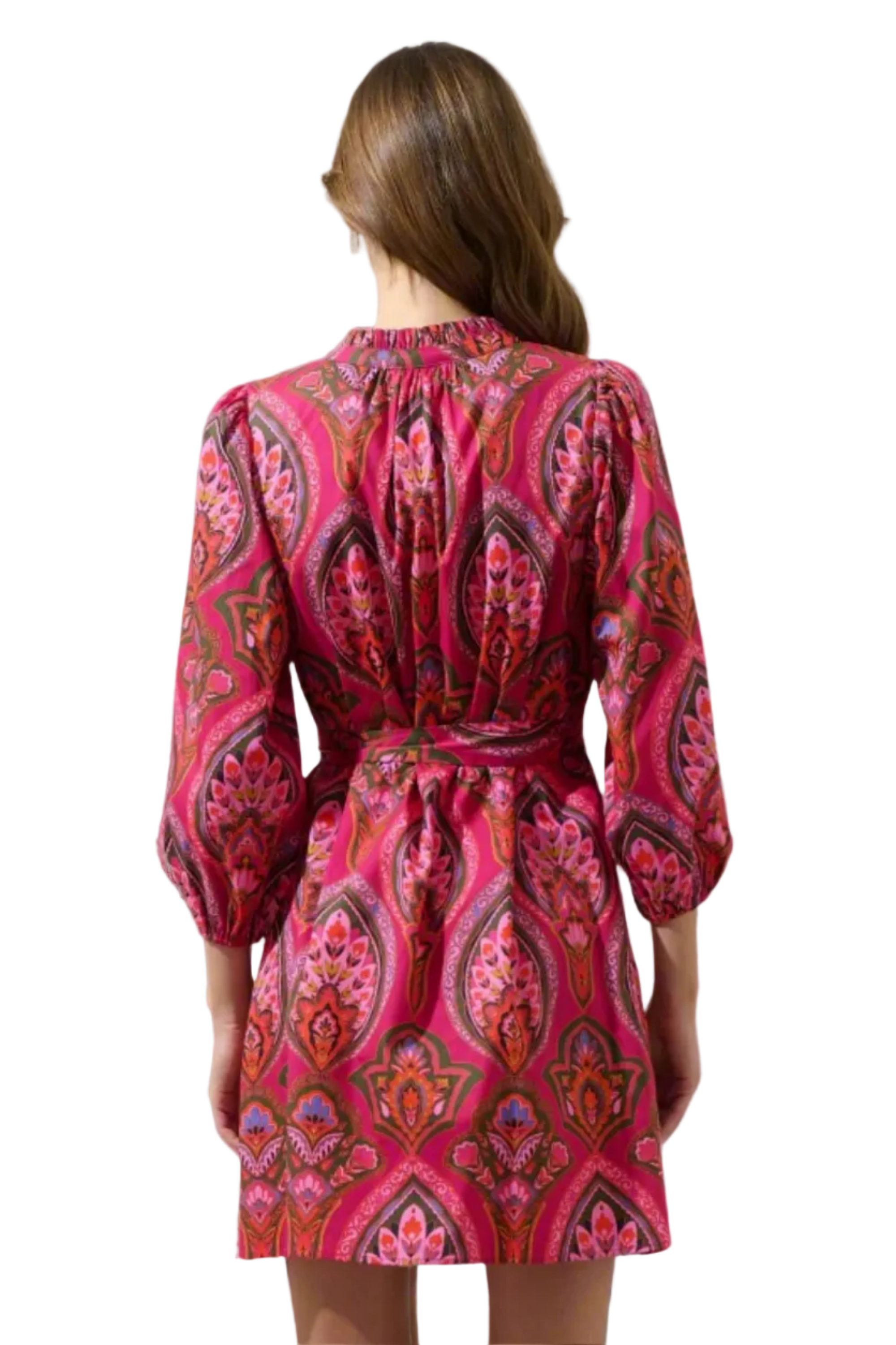 Woman wearing a pink and red patterned dress on a white background