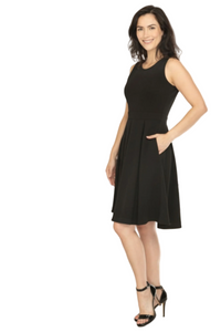 Woman in a black dress standing in an office setting