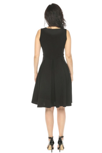 Woman wearing a black dress on a gray background