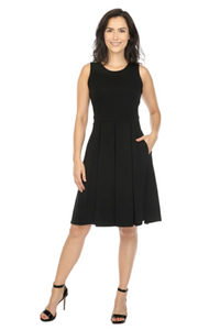 Woman wearing a black sleeveless dress on a gray background