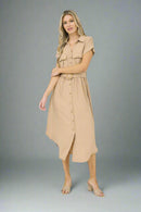 Woman wearing a beige dress on a white background
