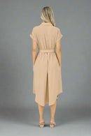 Woman wearing a beige dress on a white background