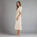 Woman wearing a white dress with a plain background