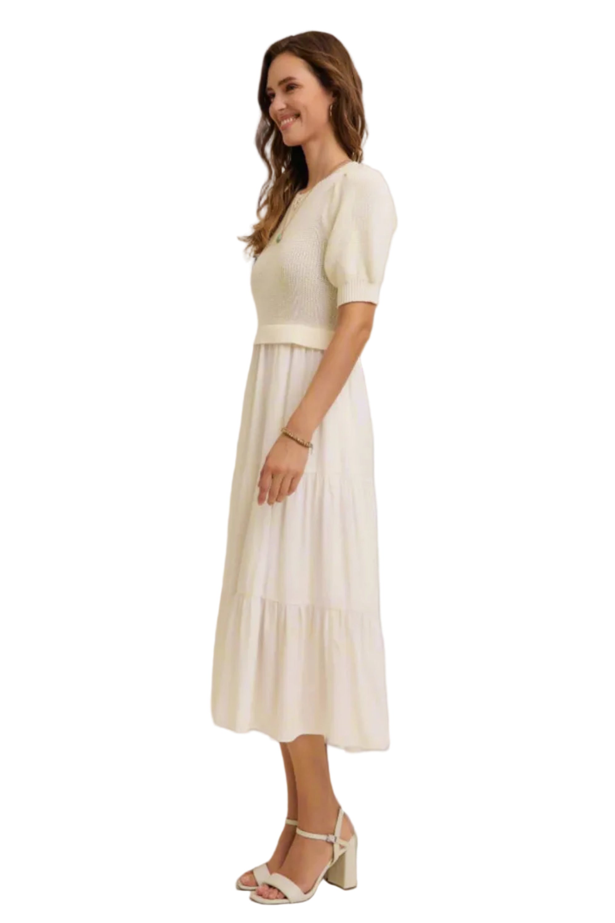 Woman wearing a white dress with a plain background