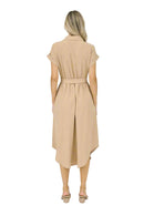 Woman wearing a beige dress on a white background