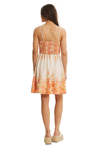 Woman wearing a floral dress with a plain background
