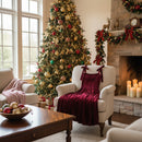 Wine colored Dress draped over a white chair in front of a fireplace and Christmas tree