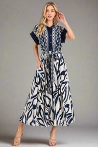 Woman wearing a blue and white patterned dress on a white background