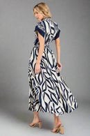 Woman wearing a zebra print dress on a white background